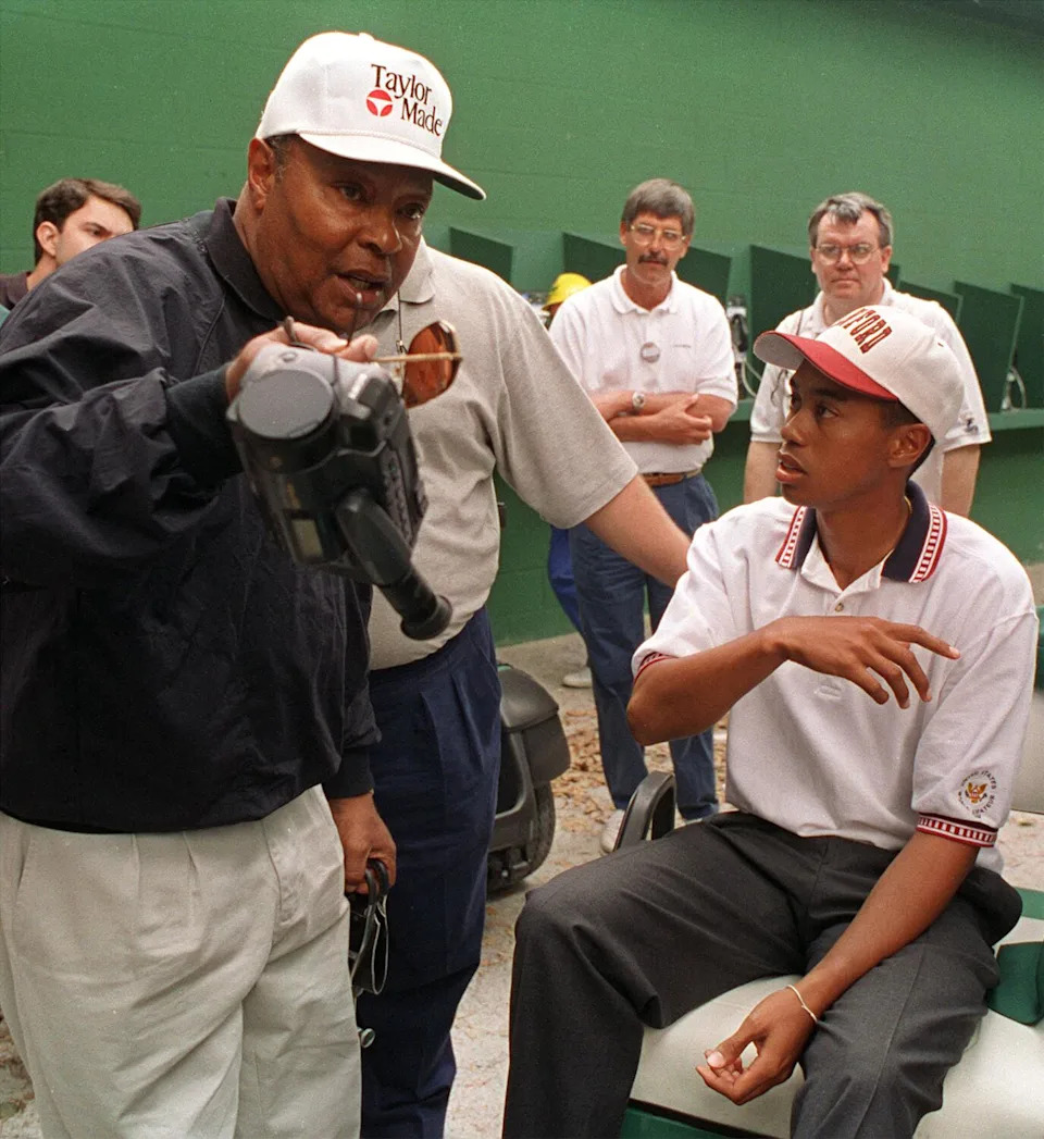 Amateur Tiger Woods, right, talks with his father, Earl Woods, after practice for the Masters golf tournament