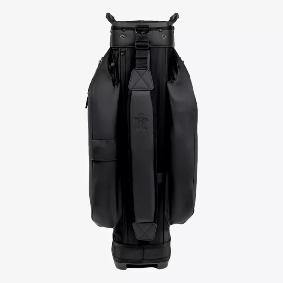 A black golf bag standing upright against a plain white background, featuring multiple pockets, a sturdy base, and a wide shoulder strap with padding for carrying comfort—an ideal pick among the best golf bags 2026.