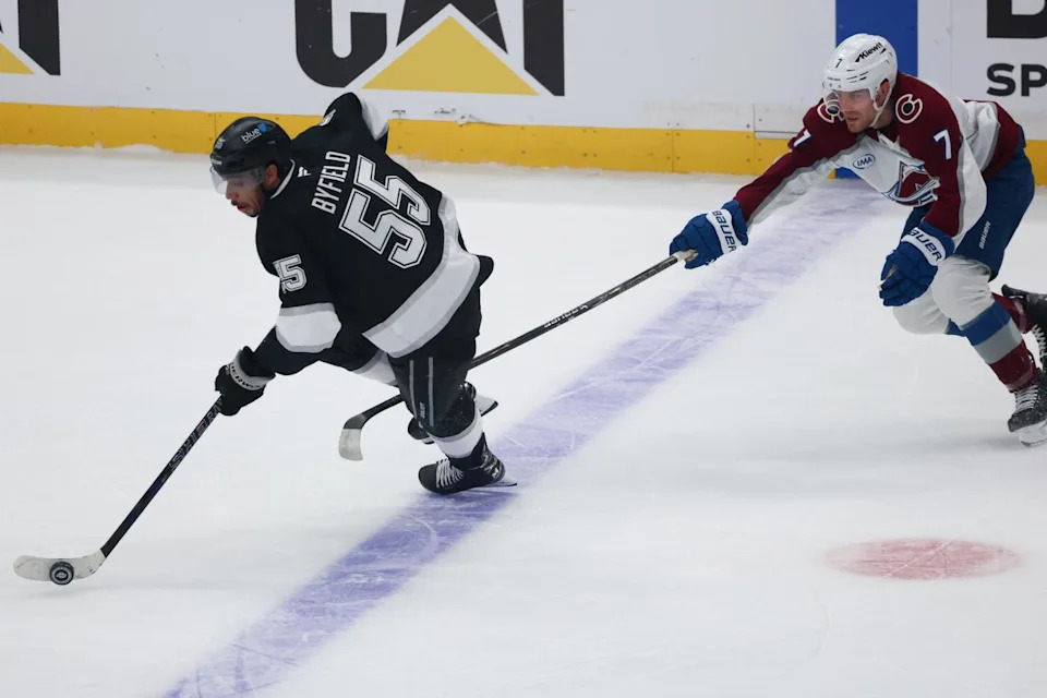 Colorado defenseman Devon Toews reaches for the puck against Kings right wing Quinton Byfield in the first period.