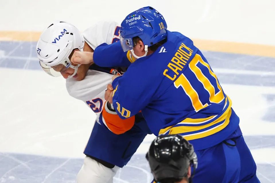 Anders Lee (27) and Sam Carrick (10) fight during the third period of the Islanders’ road loss to the Sabres. AP