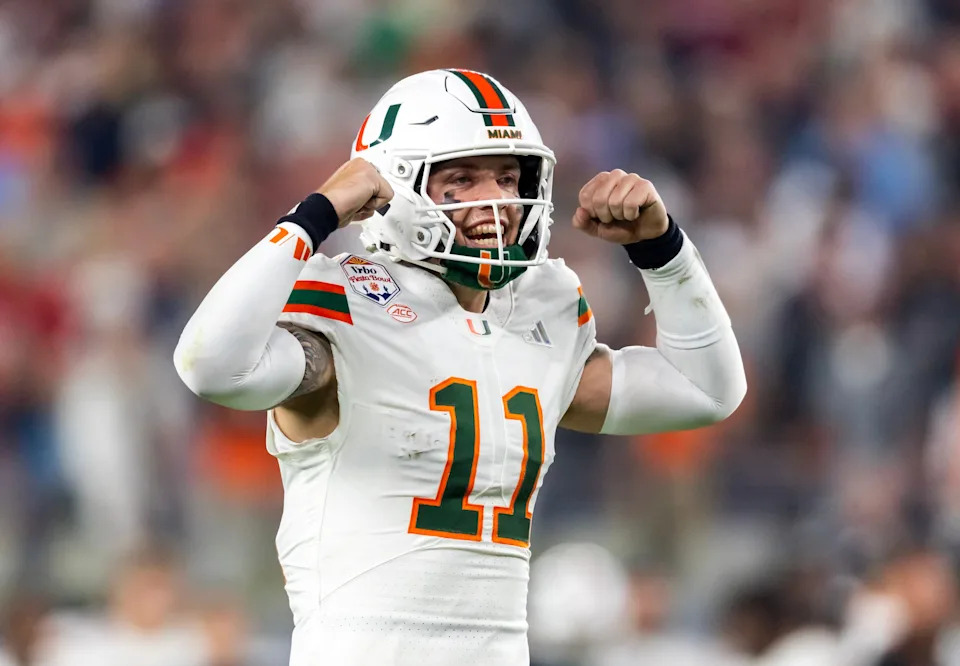 Jan 8, 2026; Glendale, AZ, USA; Miami Hurricanes quarterback Carson Beck (11) flexes his arms as he celebrates against the Mississippi Rebels during the 2026 Fiesta Bowl and semifinal game of the College Football Playoff at State Farm Stadium. Mandatory Credit: Mark J. Rebilas-Imagn Images