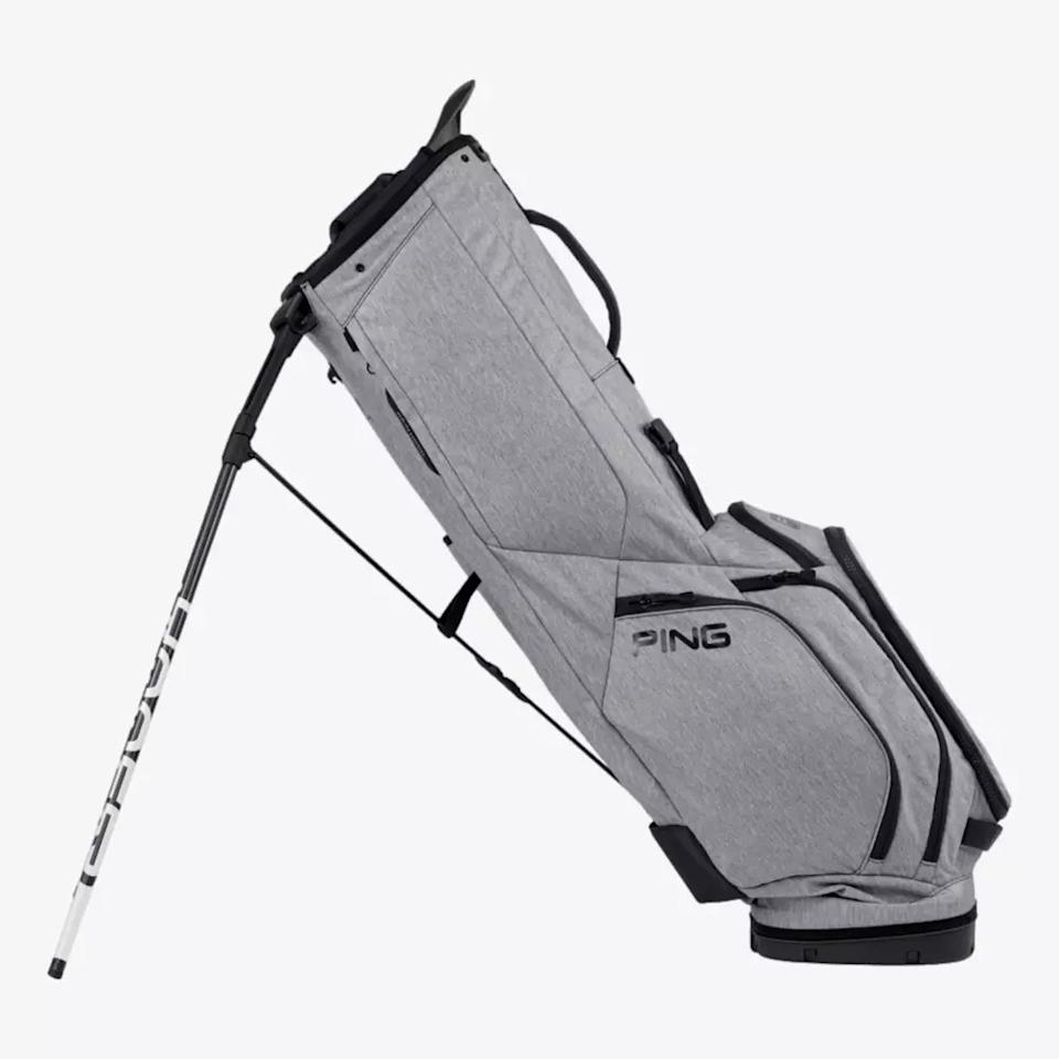 A gray PING golf bag with black accents is shown standing upright with its kickstand extended and multiple zippered pockets visible, making it a top pick among the best golf bags 2026.