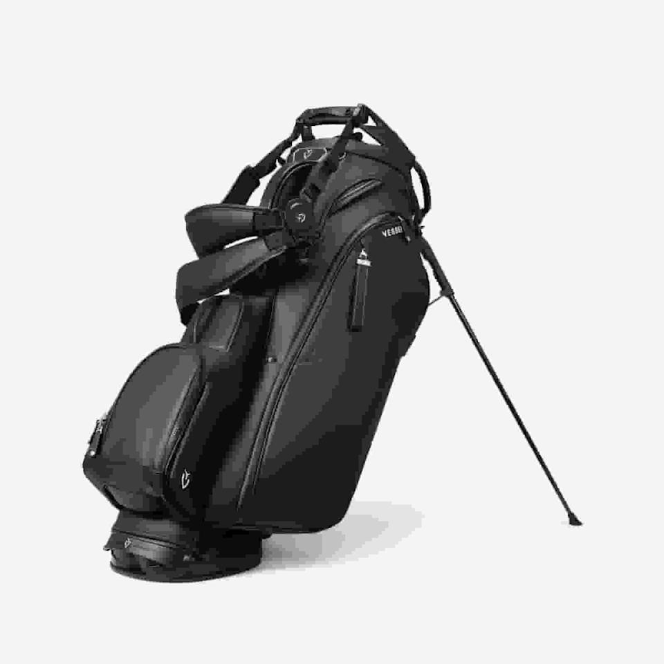 A black golf bag with multiple zippered pockets, a handle, shoulder straps, and a stand extended, positioned upright against a plain white background—an excellent choice for those seeking the best golf bags 2026.