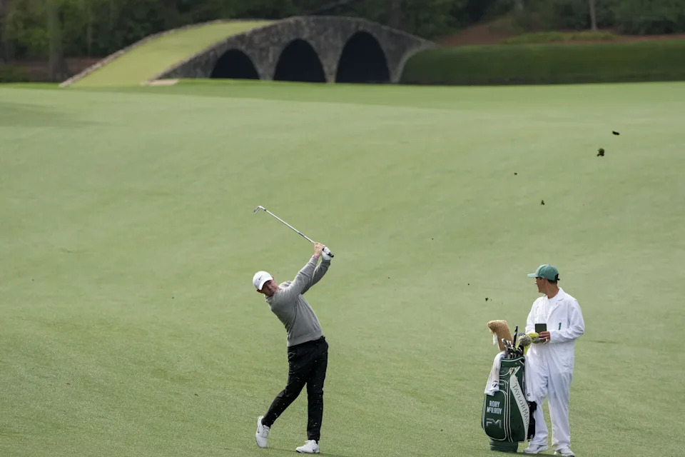 Rory McIlroy plays his ball from the 13th fairway during a practice round ahead of the 2026 Masters Tournament at Augusta National Golf Club.