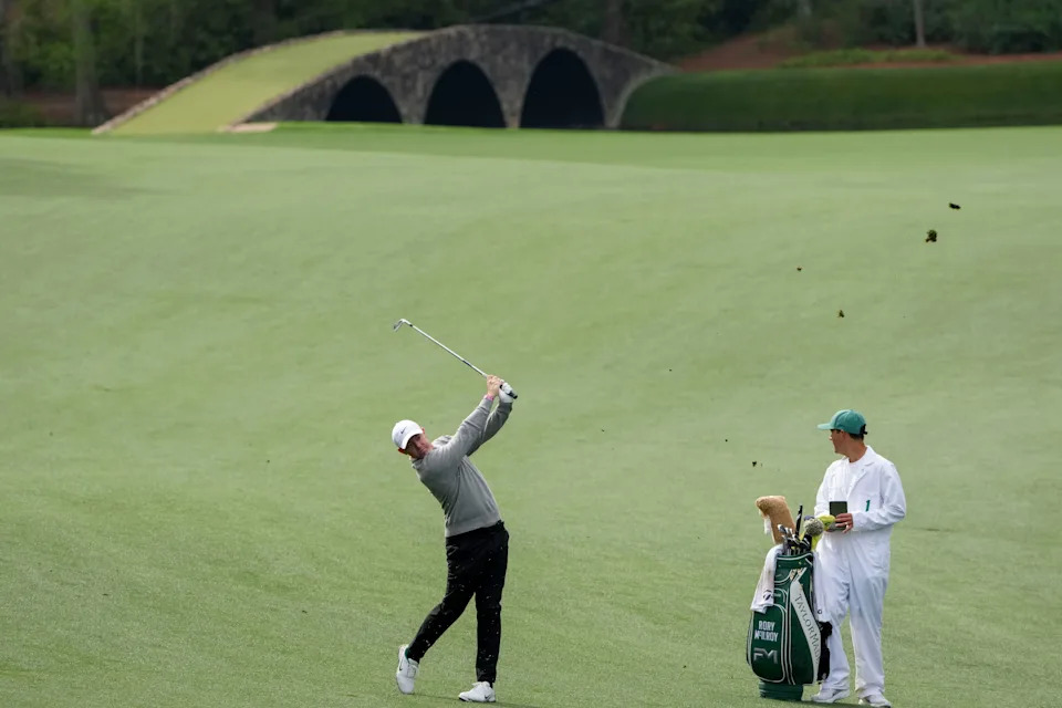 Rory McIlroy plays his ball from the No. 13 fairway during a practice round for the Masters 2026 Tournament at Augusta National Golf Club.