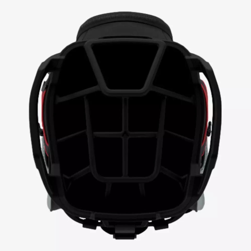 A top-down view of an empty black and red helmet, showing the internal padding and strap with a segmented structure inside—crafted with precision similar to the design found in the best golf bags 2026.