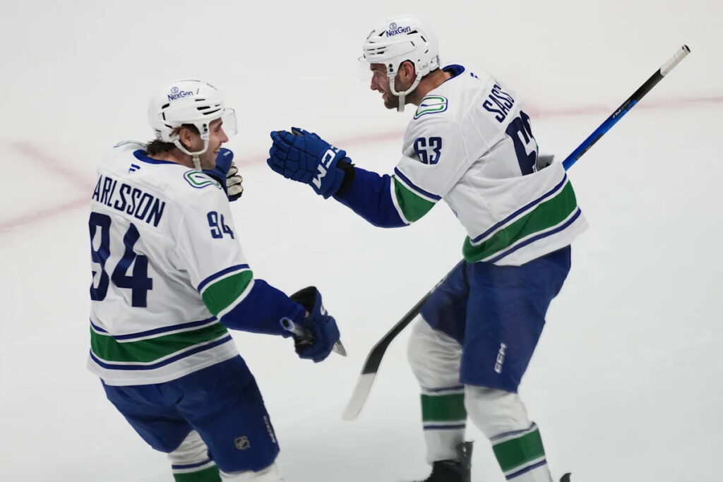 Boeser has hat trick, last-place Canucks overcome blowing 4-goal lead to beat NHL-leading Avs 8-6