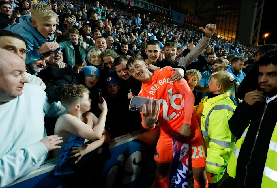 Coventry City's Josh Eccles takes a selfie with fans as they celebrate after winning promotion (Action Images via Reuters)