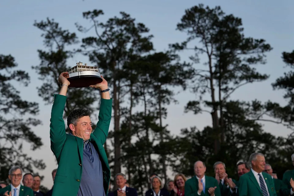 McIlroy lifts the trophy after finally winning The Masters (AP)