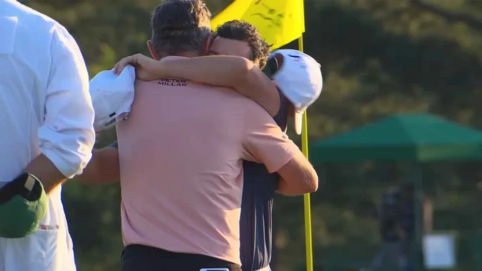 Justin Rose and Rory McIlroy embrace at the Masters