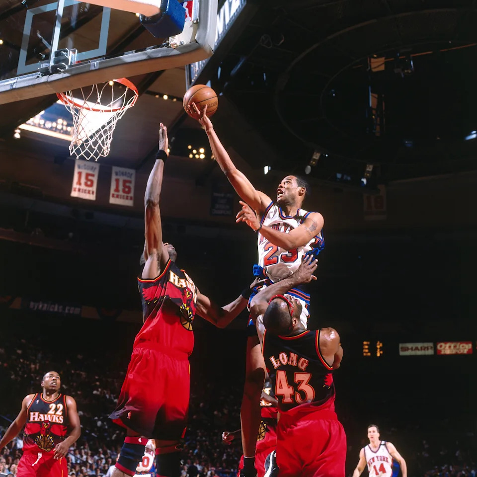 NEW YORK – MAY 23: Marcus Camby #23 of the New York Knicks shoots a layup against Dikembe Mutombo #55 of the Atlanta Hawks in Game Three of the Eastern Conference Semifinals during the 1999 NBA Playoffs at Madison Square Garden on May 23, 1999 in New York, New York. The Knicks won 90-78. NOTE TO USER: User expressly acknowledges that, by downloading and or using this photograph, User is consenting to the terms and conditions of the Getty Images License agreement. Mandatory Copyright Notice: Copyright 1999 NBAE (Photo by Nathaniel S. Butler/NBAE via Getty Images) | NBAE via Getty Images