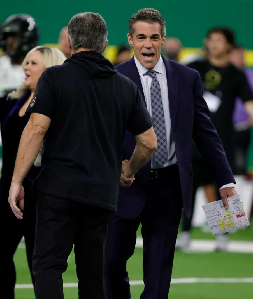 ESPN broadcaster Chris Fowler (right) greets Utah head coach Kyle Whittingham before the Utes win over Oregon in the Pac-12 Conference championship game at Allegiant Stadium on Dec. 3, 2021 in Las Vegas. Getty Images