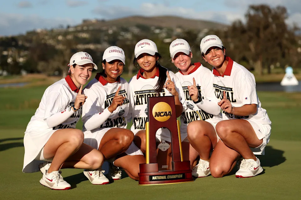Paula Martin Sampedro, Andrea Revuelta, Meja Ortengren, Kelly Xu, and Megha Ganne of the Stanford University Cardinals pose on the 18th green with the national championship trophy after defeating the USC Trojans during the final round.