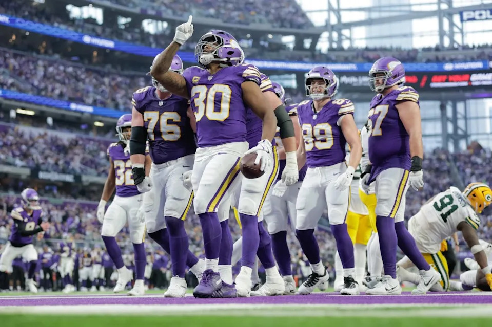 Fullback <a class="link " href="https://sports.yahoo.com/nfl/players/29951/" data-i13n="sec:content-canvas;subsec:anchor_text;elm:context_link" data-ylk="slk:C.J. Ham;sec:content-canvas;subsec:anchor_text;elm:context_link;itc:0" data-yga="{"yLinkElement":"context_link","yModuleName":"content-canvas","yLinkText":"C.J. Ham","ySubModuleName":"anchor_text","yHasCommerce":false}">C.J. Ham</a> (30) celebrate scoring during the first half of the Vikings’ win over the <a class="link " href="https://sports.yahoo.com/nfl/teams/green-bay/" data-i13n="sec:content-canvas;subsec:anchor_text;elm:context_link" data-ylk="slk:Packers;sec:content-canvas;subsec:anchor_text;elm:context_link;itc:0" data-yga="{"yLinkElement":"context_link","yModuleName":"content-canvas","yLinkText":"Packers","ySubModuleName":"anchor_text","yHasCommerce":false}">Packers</a> on Jan. 4, 2026 at U.S. Bank Stadium in Minneapolis. Icon Sportswire via Getty Images