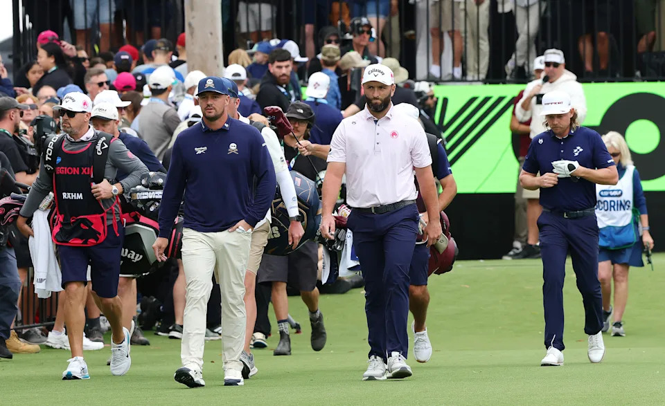 ADELAIDE, AUSTRALIA - FEBRUARY 12: Bryson DeChambeau of the Crushers GC and Jon Rahm of Legion XIII and Cameron Smith of Ripper GC walk down the 1st during day one of LIV Adelaide at The Grange Golf Club on February 12, 2026 in Adelaide, Australia. (Photo by Sarah Reed/Getty Images)