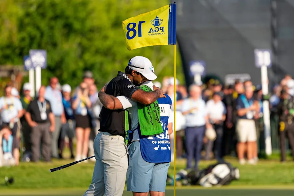 Aaron Rai, of England, hugs his caddie after his round (AP)