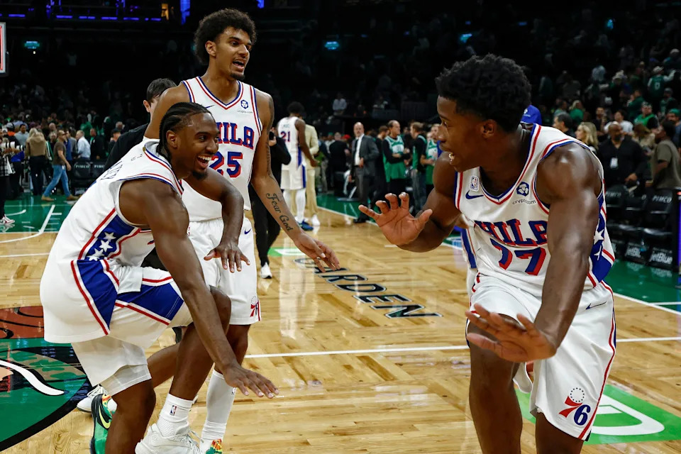 The 76ers' VJ Edgecombe (77), Tyrese Maxey (0) and Dominick Barlow (25) celebrate after defeating the Boston Celtics, 117-116,  at TD Garden on Oct. 22, 2025.