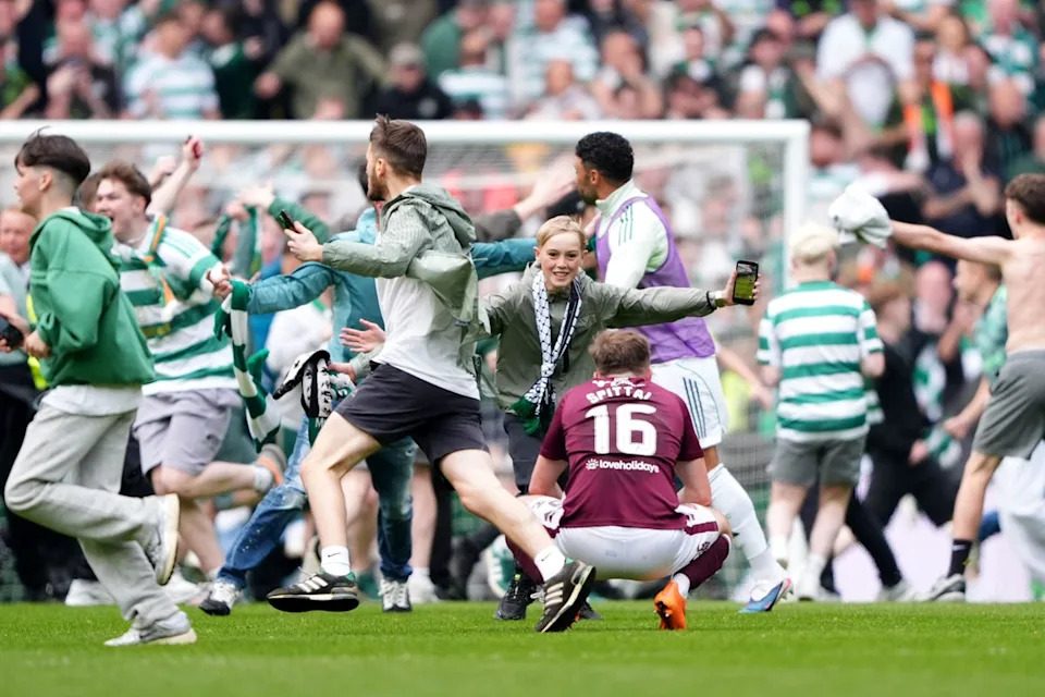 Fans streamed on to the pitch before full-time (PA Wire)