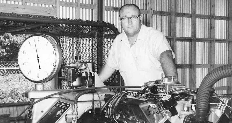 John Holman poses with a motor in 1950.