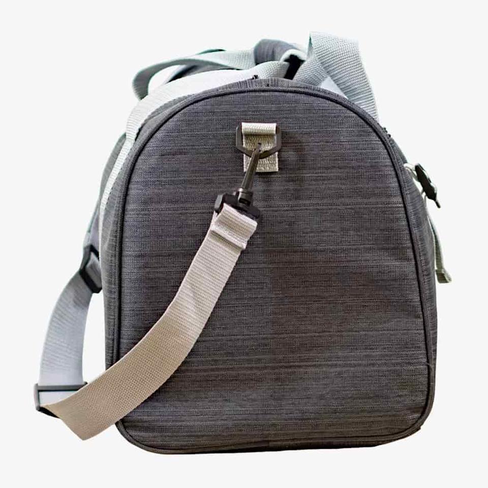 A gray fabric shoulder bag with a rounded top, light gray adjustable straps, and a metal buckle—perfect for carrying the best golf rangefinders—shown standing upright against a plain white background.