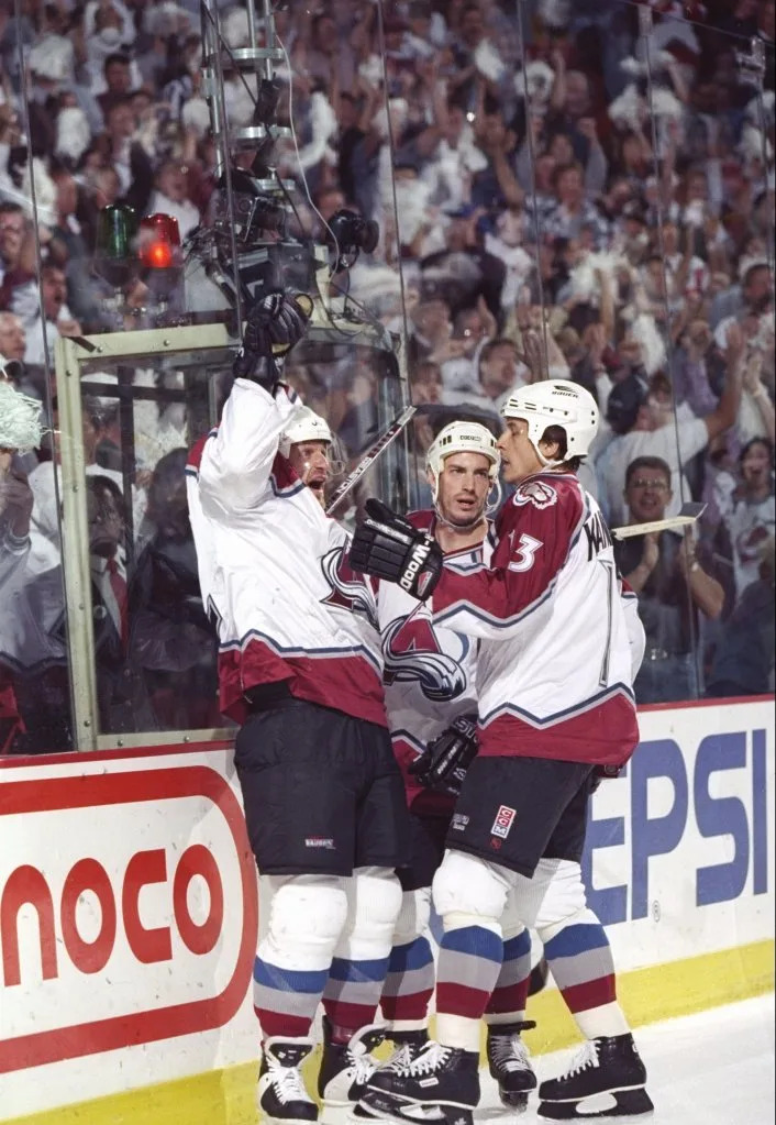 Right wing Claude Lemieux, center Joe Sakic, and left wing Valeri Kamensky of the <a class="link " href="https://sports.yahoo.com/nhl/teams/detroit/" data-i13n="sec:content-canvas;subsec:anchor_text;elm:context_link" data-ylk="slk:Detroit Red Wings;sec:content-canvas;subsec:anchor_text;elm:context_link;itc:0" data-yga="{"yLinkElement":"context_link","yModuleName":"content-canvas","yLinkText":"Detroit Red Wings","ySubModuleName":"anchor_text","yHasCommerce":false}">Detroit Red Wings</a> celebrate a goal during a playoff game against the Colorado Avalanche at the McNichols Sports Arena in Denver, Colorado. Getty Images