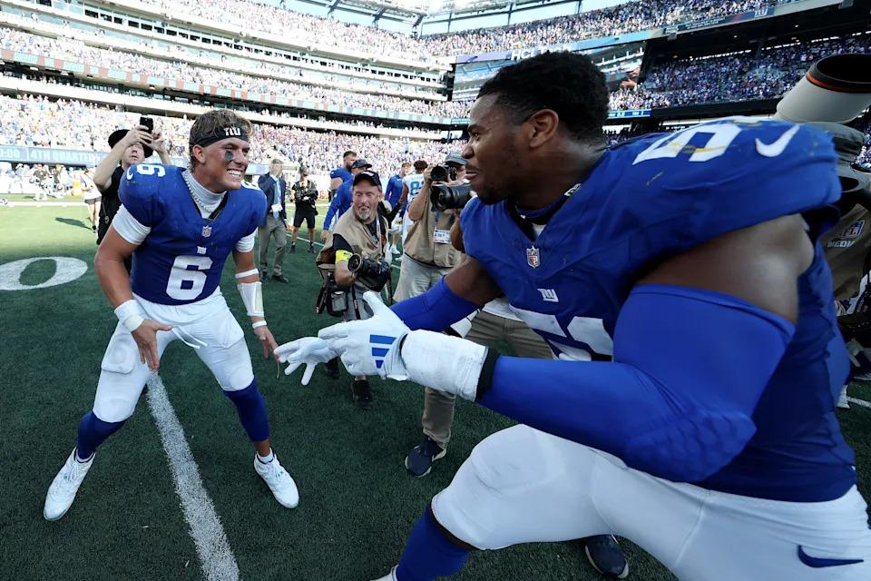 EAST RUTHERFORD, NEW JERSEY - SEPTEMBER 28: Jaxson Dart #6 of the New York Giants and Abdul Carter #51 of the New York Giants celebrate following a win against the Los Angeles Chargers after the game at MetLife Stadium on September 28, 2025 in East Rutherford, New Jersey. (Photo by Al Bello/Getty Images)