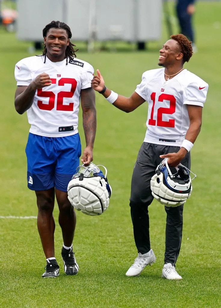 Arvell Reese (52) and cornerback Colton Hood (12) share a laugh <br>during Giants football practice. Noah K. Murray for NY Post