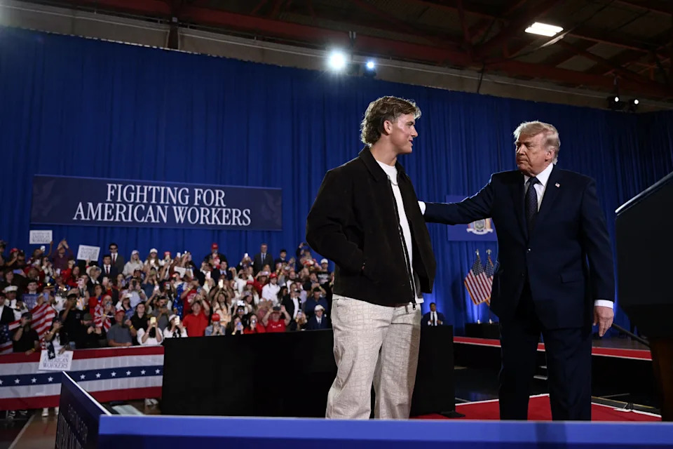 President Donald Trump is welcomed by New York Giants quarterback Jaxson Dart before delivering a speech at Rockland Community College Fieldhouse in Suffern, New York, on May 22.