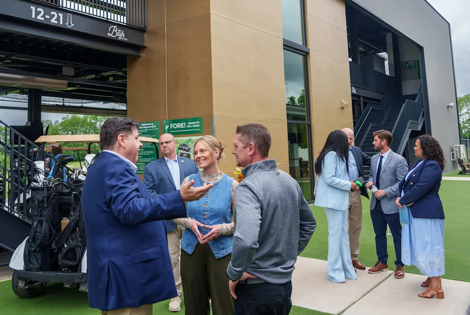 Gov. JB Pritzker chats with Golf Learning Center developer Matt Rixner and his wife Cortney after the ribbon-cutting ceremony for the facility Tuesday, May 19, 2026 in Peoria.