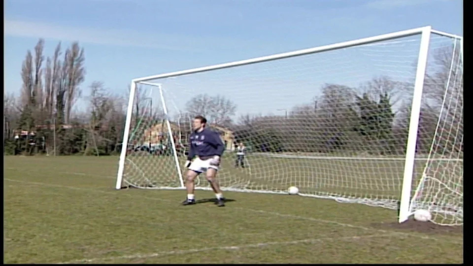 A picture of a goalkeeper stood in an oversized goal