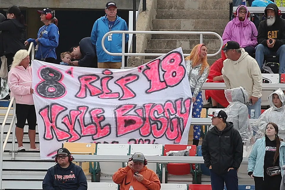 Fans in the grandstands display a sign in tribute to the passing of Kyle Busch.