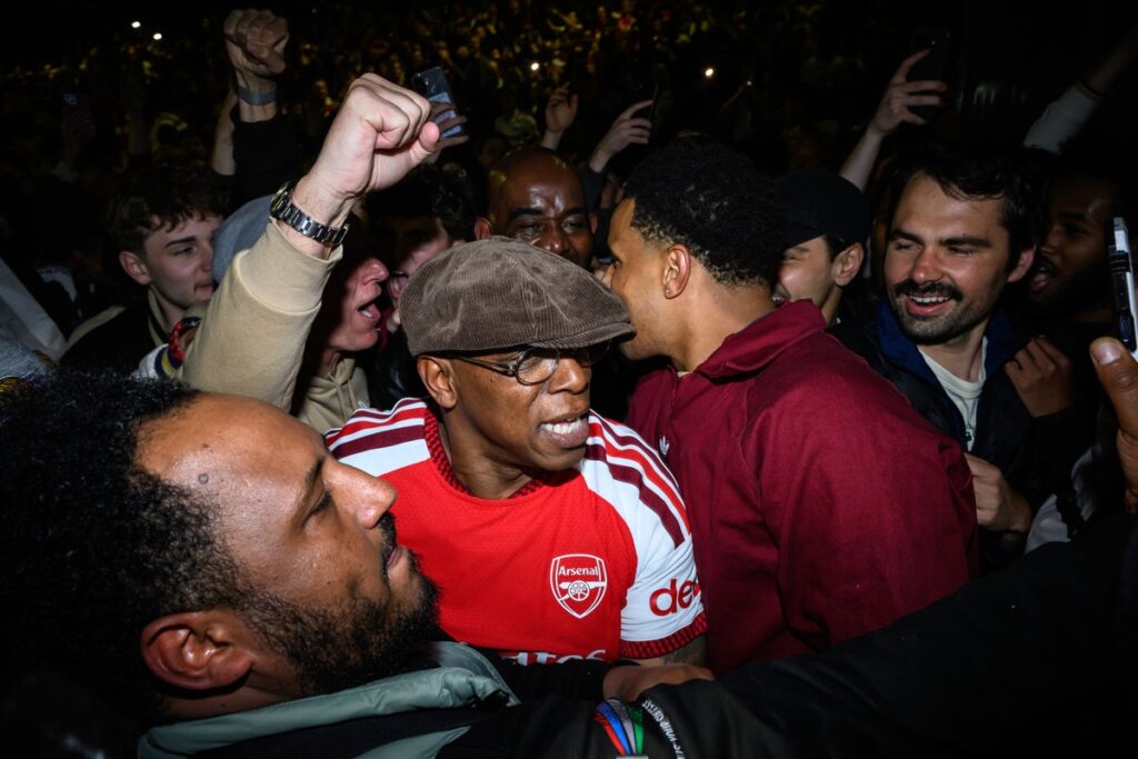 Ian Wright celebrates with Arsenal fans after securing long-awaited Premier League title