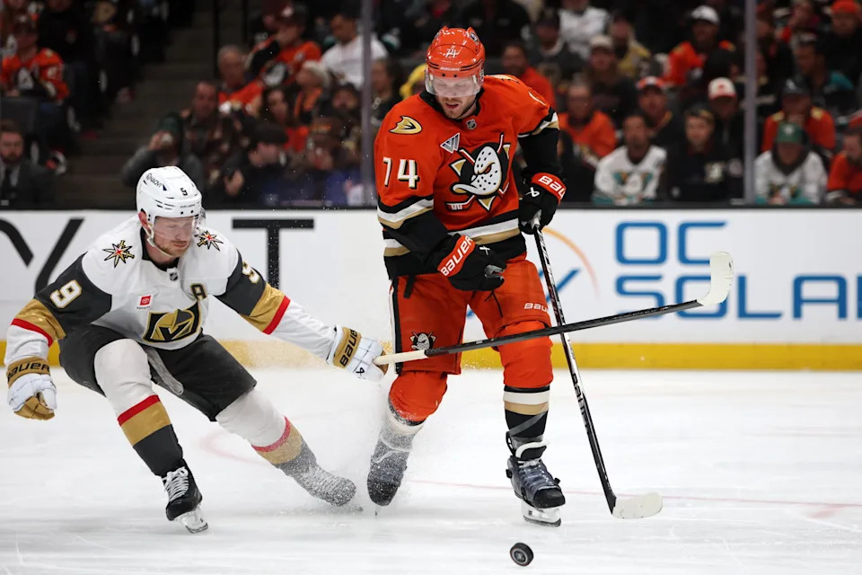May 14, 2026; Anaheim, California, USA; Anaheim Ducks defenseman John Carlson (74) fights for the puck against Vegas Golden Knights center Jack Eichel (9) during the third period of game six of the second round of the 2026 Stanley Cup Playoffs at Honda Center. Mandatory Credit: Kiyoshi Mio-Imagn Images