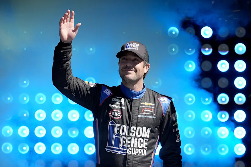 MARTINSVILLE, VIRGINIA - MARCH 28: Lee Pulliam, driver of the #9 Folsom Fence Supply Chevrolet, waves to fans as he walks onstage during driver intros prior to the NASCAR O