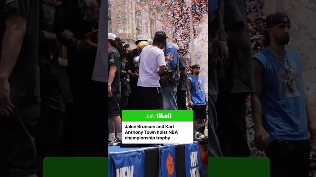 Knicks superstars, Jalen Brunson and Karl Anthony Towns, pass the trophy to one another during the