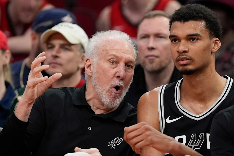 Gregg Popovich, left, talks with Victor Wembanyama on the bench during the first half of an NBA basketball game against the Houston Rockets March 5, 2024. AP Photo/David J. Phillip