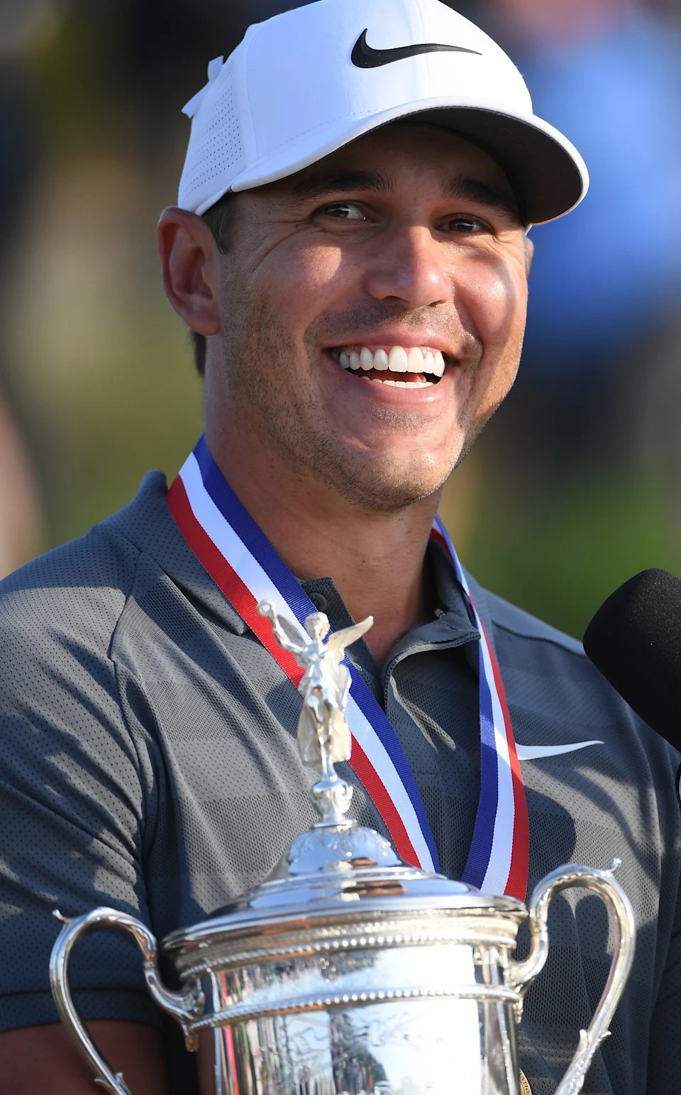 SOUTHAMPTON, NY - JUNE 17: Brooks Koepka of the United States celebrates with the winners trophy after the final round of the 2018 U.S. Open at Shinnecock Hills Golf Club on June 17, 2018 in Southampton, New York. (Photo by Ross Kinnaird/Getty Images)