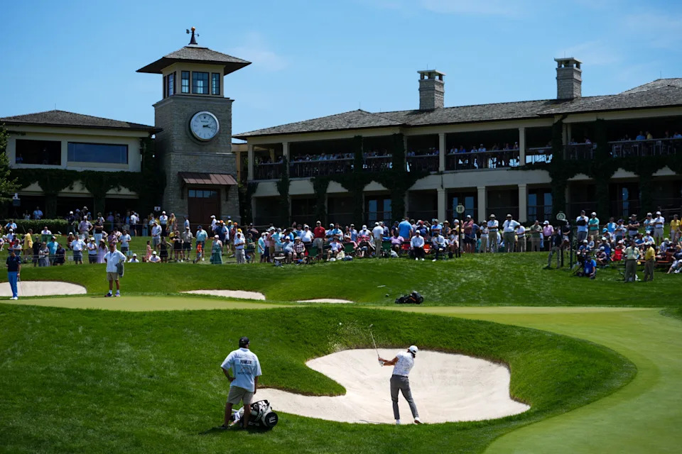 Rickie Fowler plays his shot from a bunker on the 18th hole during the first round of the 2026 Memorial Tournament.