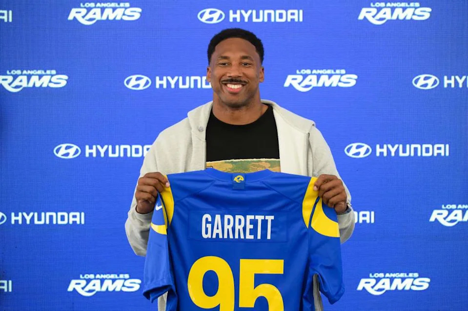 Myles Garret holding a Rams jersey during his introductory press conference. AP Photo/Kyusung Gong