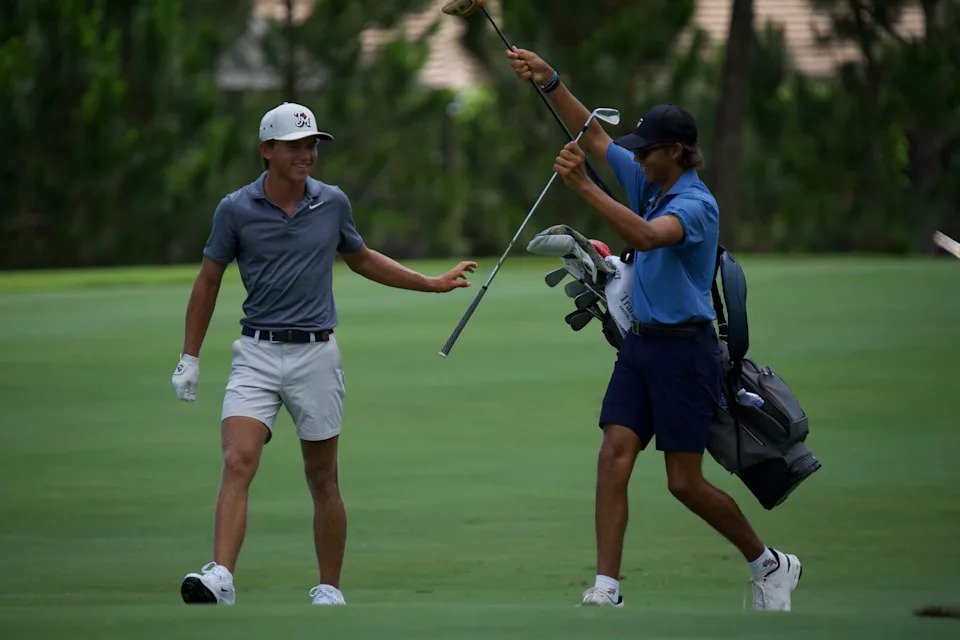 Miles Russell (left) plays a U.S. Open qualifier with Charlie Woods (right) as his caddy on Monday, June 8 at the BallenIsles Country Club (East) in Palm Beach Gardens, Florida.