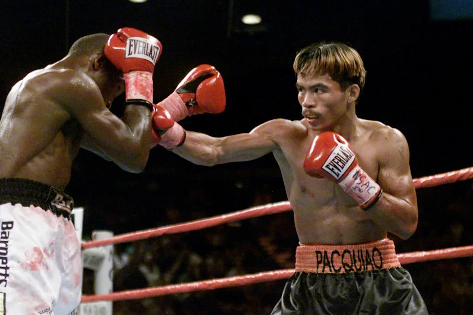 23 Jun 2001: Manny Pacquiao (R) throws a right jab against a blocking Lehlohonolo Ledwaba during IBF Super Bantamweight Championship bout at the MGM Grand Hotel & Casino in Las Vegas, Nevada.  Pacquiao won the bout by way of knockout after 6 rounds. DIGITAL IMAGE. Mandatory Credit: Jed Jacobsohn/Allsport