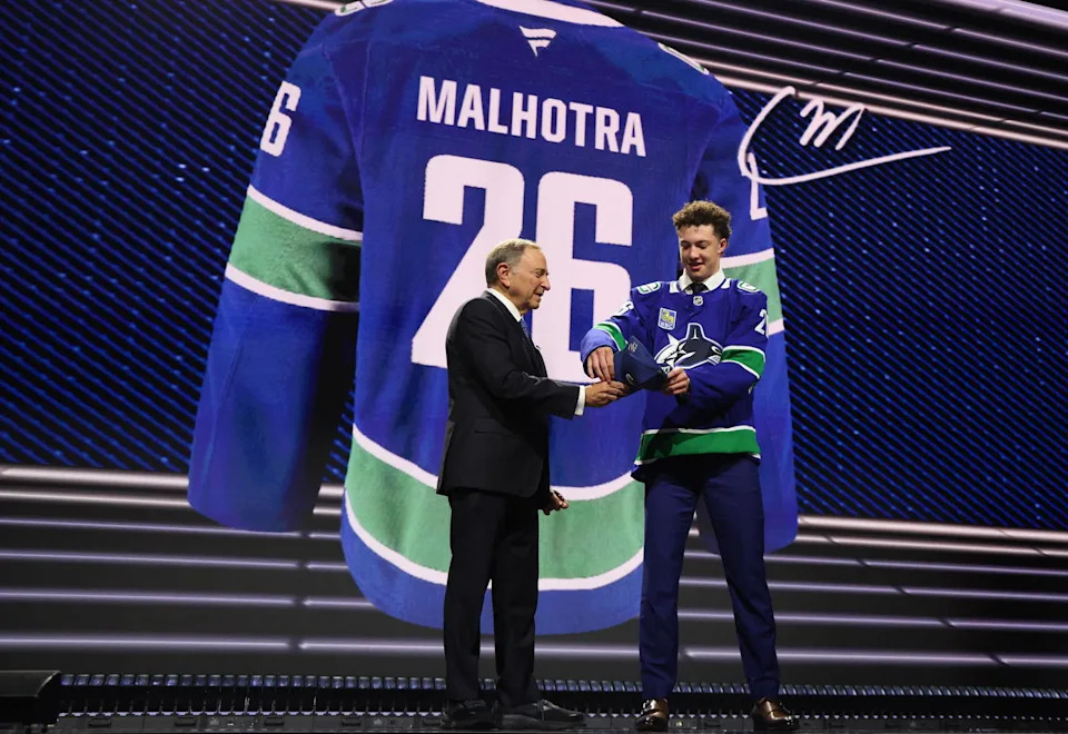 Jun 26, 2026; Buffalo, New York, USA; Caleb Malhotra reacts with NHL commissioner Gary Bettman after being selected with the third pick in the first round of the 2026 NHL Draft by the Vancouver Canucks at KeyBank Center. Mandatory Credit: Timothy T. Ludwig-Imagn Images