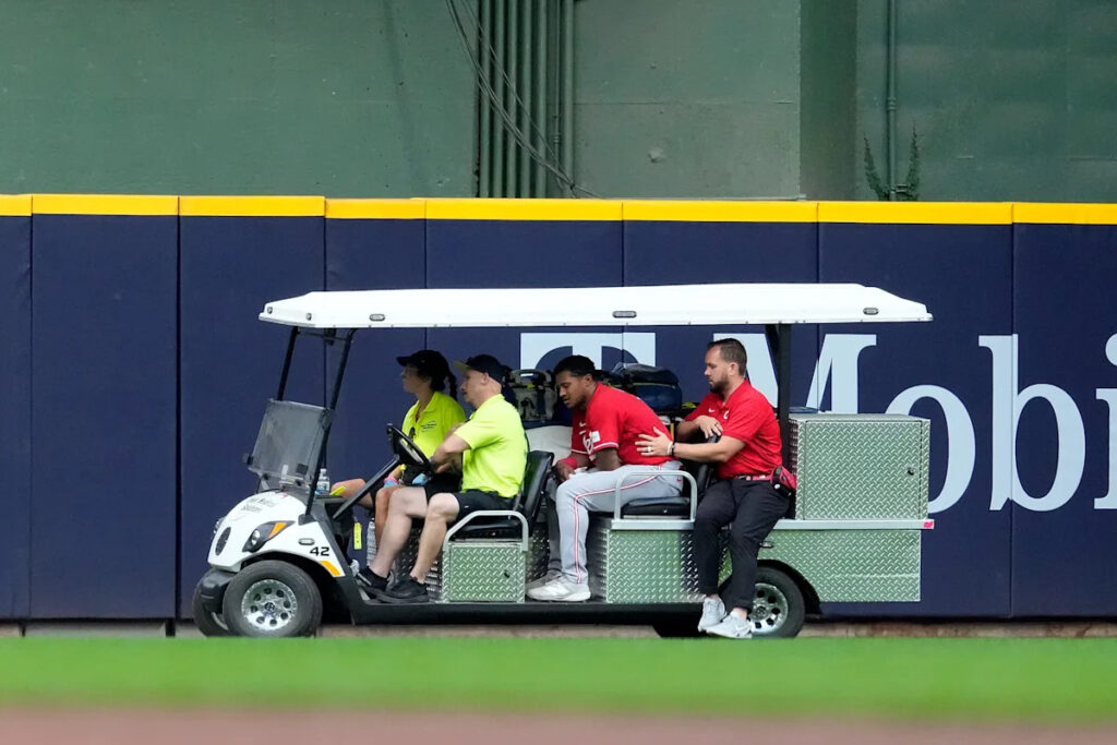 Reds’ Dane Myers carted off field after ridiculous catch, scary collision with wall in loss to Brewers