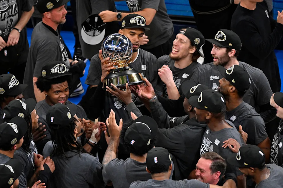 The San Antonio Spurs celebrate with the Oscar Robertson trophy after defeating the Oklahoma City Thunder in Game 7 of the Western Conference finals on May 30, 2026.