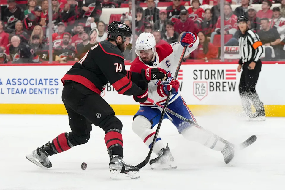 Carolina Hurricanes defenseman Jaccob Slavin (74) challenges Montreal Canadiens center Nick Suzuki (14) for the puck during the conference finals.