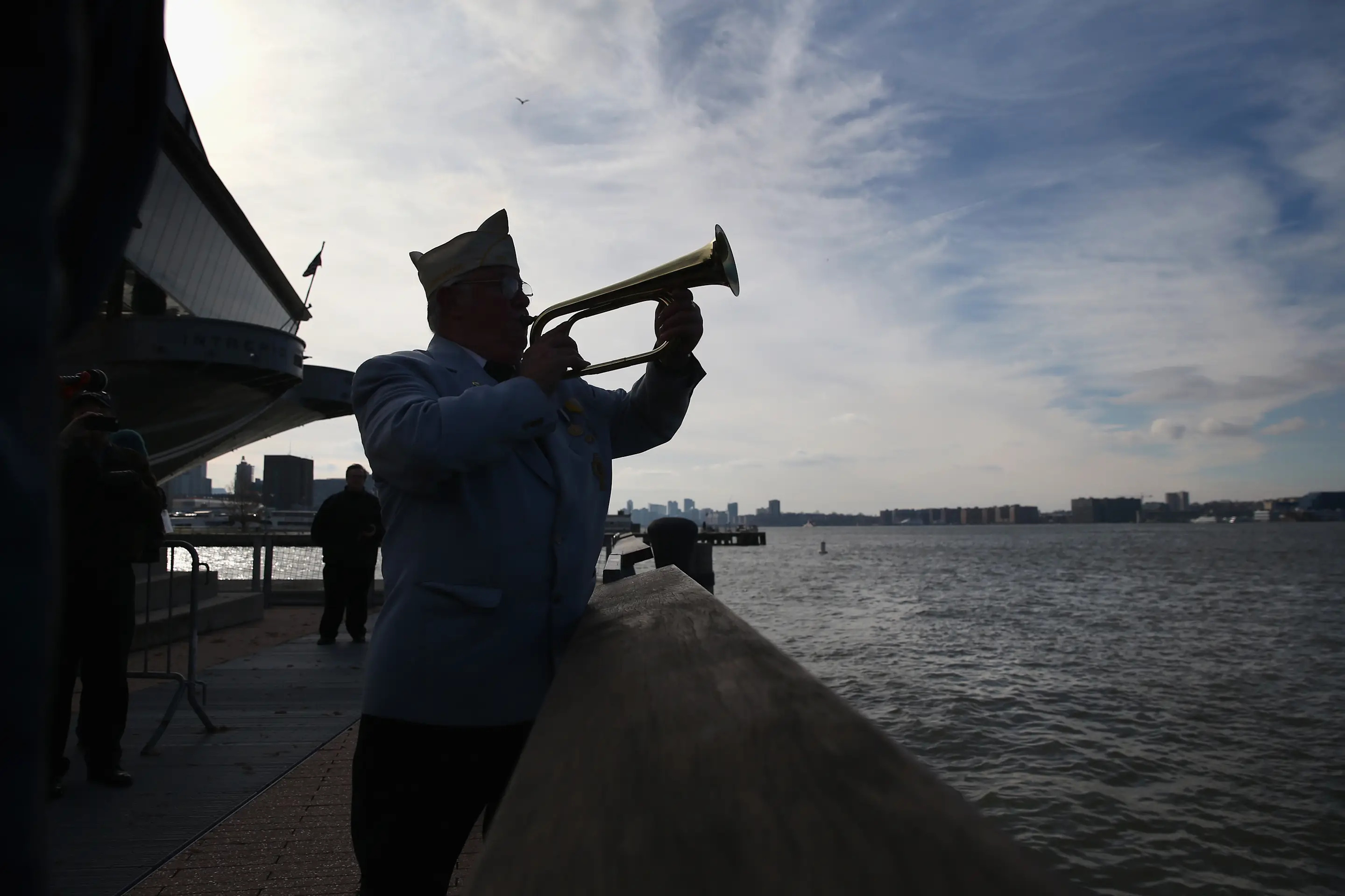 NEW YORK, NY - DECEMBER 07: A bugler plays Taps at a ceremony marking the 72nd anniversary of the attack on Pearl Harbor, Hawaii on December 7, 2013 in New York City. Four Pearl Harbor survivors from the New York area gathered with former crew members of the USS Intrepid to mark the Japanese surprise attack on December 7, 1941 which killed 2,402 Americans and brought the United States into WWII. (Photo by John Moore/Getty Images)