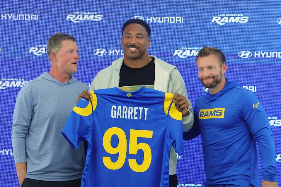 Myles Garrett #95 of the Los Angeles Rams poses with general manager Les Snead and head coach Sean McVay during a Getty Images
