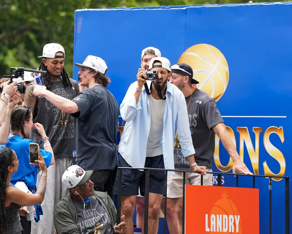 The Knicks’ Landry Shamet takes photos during the 2026 NBA championship parade on June 18, 2026 in New York City. NBAE via Getty Images