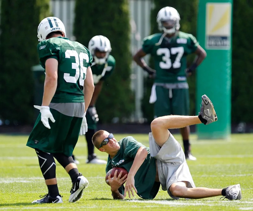 Seth Ryan, right, son of former Jets head coach Rex Ryan, goes down as he makes a catch with <a class="link " href="https://sports.yahoo.com/nfl/players/7442/" data-i13n="sec:content-canvas;subsec:anchor_text;elm:context_link" data-ylk="slk:Jim Leonhard;sec:content-canvas;subsec:anchor_text;elm:context_link;itc:0" data-yga="{"yLinkElement":"context_link","yModuleName":"content-canvas","yLinkText":"Jim Leonhard","ySubModuleName":"anchor_text","yHasCommerce":false}">Jim Leonhard</a> (36) during training camp on Aug. 1, 2011, at Atlantic Health Training Center in Florham Park. AP Photo/Julio Cortez