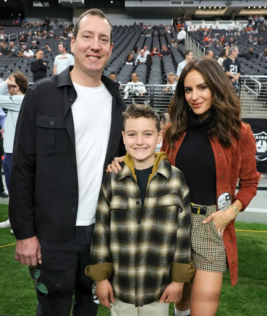 NASCAR driver Kyle Busch, his son Brexton Busch and wife Samantha Busch pose for photos on the Las Vegas Raiders’ sideline before a game between the Raiders and the Denver Broncos at Allegiant Stadium on Nov. 24, 2024. Getty Images